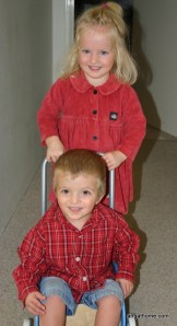 twins pushing trolley